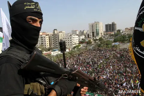 A Palestinian Islamic Jihad militant stands guard on a roof during a rally marking the 29th anniversary of the movement foundation in Gaza City October 21, 2016. Photo by Abed Rahim Khatib