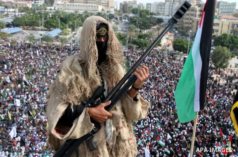 A Palestinian Islamic Jihad militant stands guard on a roof during a rally marking the 29th anniversary of the movement foundation in Gaza City October 21, 2016. Photo by Abed Rahim Khatib