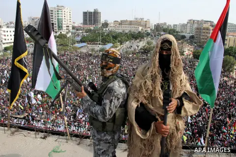 Snipers of Palestinian Islamic Jihad militant take up positions on a roof during a rally marking the 29th anniversary of the movement foundation in Gaza City October 21, 2016. Photo by Abed Rahim Khatib
