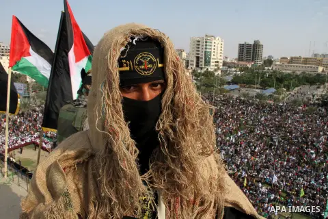 A Palestinian Islamic Jihad militant stands guard on a roof during a rally marking the 29th anniversary of the movement foundation in Gaza City October 21, 2016. Photo by Abed Rahim Khatib