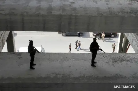 Palestinian Islamic Jihad militants stand guard on a roof during a rally marking the 29th anniversary of the movement foundation in Gaza City October 21, 2016. Photo by Abed Rahim Khatib