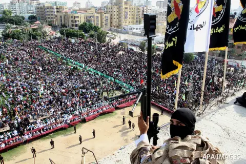 A Palestinian Islamic Jihad militant stands guard on a roof during a rally marking the 29th anniversary of the movement foundation in Gaza City October 21, 2016. Photo by Abed Rahim Khatib