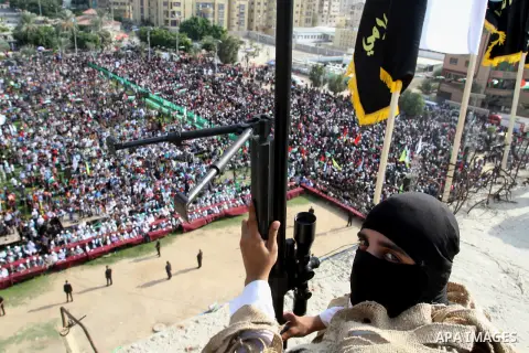 A Palestinian Islamic Jihad militant stands guard on a roof during a rally marking the 29th anniversary of the movement foundation in Gaza City October 21, 2016. Photo by Abed Rahim Khatib