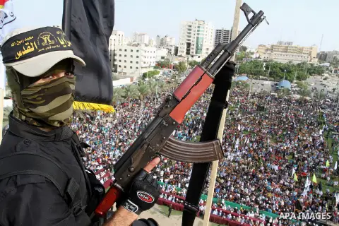 A Palestinian Islamic Jihad militant stands guard on a roof during a rally marking the 29th anniversary of the movement foundation in Gaza City October 21, 2016. Photo by Abed Rahim Khatib