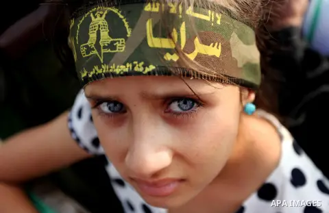 A Palestinian girl attends a rally marking the 29th anniversary of the foundation of the Islamic Jihad movement in Gaza City October 21, 2016. Photo by Ashraf Amra