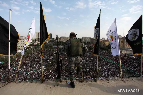 A Palestinian Islamic Jihad militant stands guard on a roof during a rally marking the 29th anniversary of the movement foundation in Gaza City October 21, 2016. Photo by Ashraf Amra