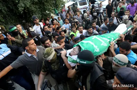 Palestinian members of the Ezzedine al-Qassam Brigades, the armed wing of the Hamas movement carry the body of a Palestinian fellow militant, Anas Salama Abu Lasheen, 22, who died after a tunnel collapse in the Gaza Stri...
