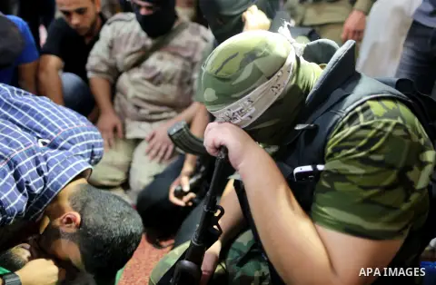 Relatives of a Palestinian member of the Ezzedine al-Qassam Brigades, the armed wing of the Hamas Anas Salama Abu Lasheen, 22, who died after a tunnel collapse in the Gaza Strip mourn during his funeral, in the al-Maghaz...