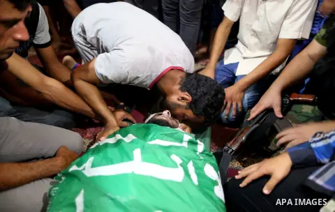 Relatives of a Palestinian member of the Ezzedine al-Qassam Brigades, the armed wing of the Hamas Anas Salama Abu Lasheen, 22, who died after a tunnel collapse in the Gaza Strip mourn during his funeral, in the al-Maghaz...