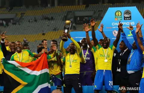South Africa's Mamelodi Sundowns players celebrate after winning the CAF Champions League football competition following the final match against Egypt's Zamalek club on October 23, 2016 at the Borg el-Arab Stadium near A...