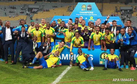 South Africa's Mamelodi Sundowns players celebrate after winning the CAF Champions League football competition following the final match against Egypt's Zamalek club on October 23, 2016 at the Borg el-Arab Stadium near A...