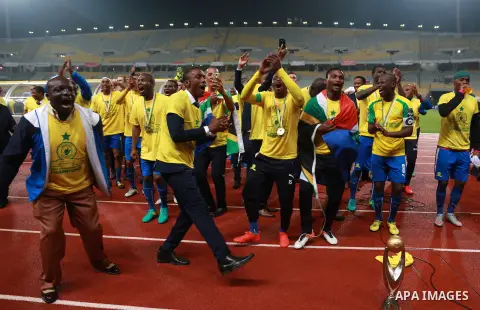 South Africa's Mamelodi Sundowns players celebrate after winning the CAF Champions League football competition following the final match against Egypt's Zamalek club on October 23, 2016 at the Borg el-Arab Stadium near A...