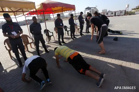 Palestinian applicants undergo a physical examination at a Hamas-run police recruitment centre in Gaza City October 24, 2016. Photo by Mohammed Asad
