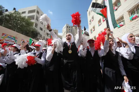 Palestinian students celebrate after winning the Best School Competition "challenge the Arab reading" of the more than 30 thousand schools in the Arab world, in the West Bank city of Nablus, on October 24, 2016. Photo by...