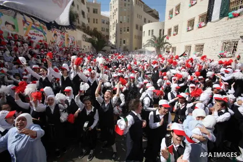 Palestinian students celebrate after winning the Best School Competition "challenge the Arab reading" of the more than 30 thousand schools in the Arab world, in the West Bank city of Nablus, on October 24, 2016. Photo by...