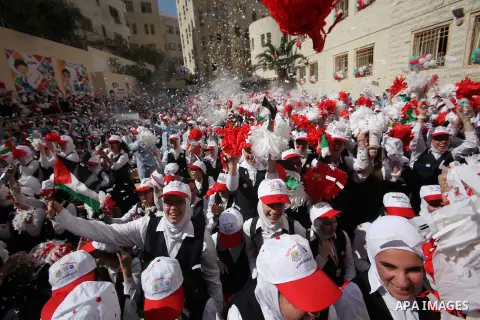 Palestinian students celebrate after winning the Best School Competition "challenge the Arab reading" of the more than 30 thousand schools in the Arab world, in the West Bank city of Nablus, on October 24, 2016. Photo by...