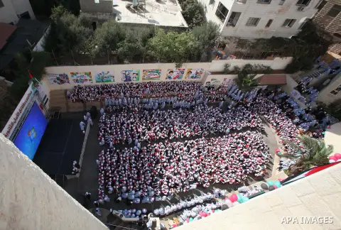 Palestinian students celebrate after winning the Best School Competition "challenge the Arab reading" of the more than 30 thousand schools in the Arab world, in the West Bank city of Nablus, on October 24, 2016. Photo by...