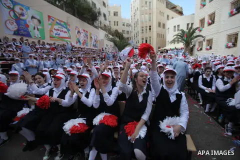 Palestinian students celebrate after winning the Best School Competition "challenge the Arab reading" of the more than 30 thousand schools in the Arab world, in the West Bank city of Nablus, on October 24, 2016. Photo by...