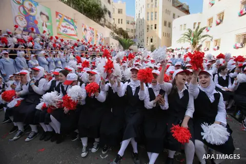 Palestinian students celebrate after winning the Best School Competition "challenge the Arab reading" of the more than 30 thousand schools in the Arab world, in the West Bank city of Nablus, on October 24, 2016. Photo by...
