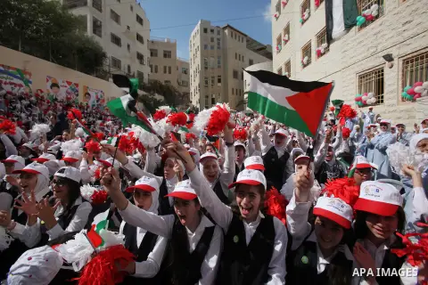 Palestinian students celebrate after winning the Best School Competition "challenge the Arab reading" of the more than 30 thousand schools in the Arab world, in the West Bank city of Nablus, on October 24, 2016. Photo by...