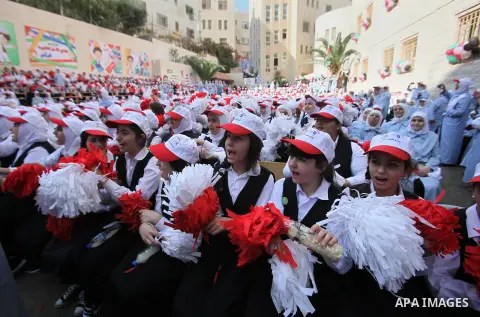 Palestinian students celebrate after winning the Best School Competition "challenge the Arab reading" of the more than 30 thousand schools in the Arab world, in the West Bank city of Nablus, on October 24, 2016. Photo by...