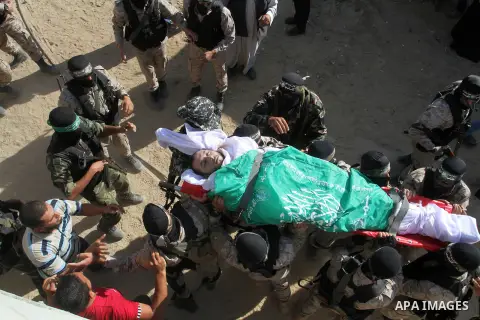 Members of the Ezzedine al-Qassam Brigades, the military wing of the Palestinian Islamist movement Hamas, carry the body of a fellow Palestinian militant, Amir Jaber Abu Taimeh, during his funeral in Khan Yunis in the so...