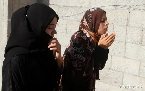 Relatives of Amir Jaber Abu Taimeh, a member of the Ezzedine al-Qassam Brigades, the military wing of the Palestinian Islamist movement Hamas, mourn during his funeral in Khan Yunis in the southern Gaza Strip on October...