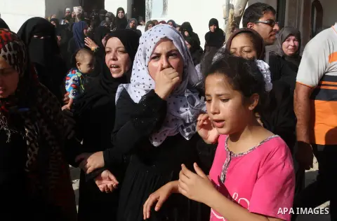 Relatives of Amir Jaber Abu Taimeh, a member of the Ezzedine al-Qassam Brigades, the military wing of the Palestinian Islamist movement Hamas, mourn during his funeral in Khan Yunis in the southern Gaza Strip on October...