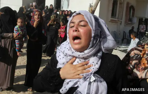 Relatives of Amir Jaber Abu Taimeh, a member of the Ezzedine al-Qassam Brigades, the military wing of the Palestinian Islamist movement Hamas, mourn during his funeral in Khan Yunis in the southern Gaza Strip on October...