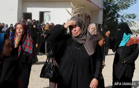 Relatives of Amir Jaber Abu Taimeh, a member of the Ezzedine al-Qassam Brigades, the military wing of the Palestinian Islamist movement Hamas, mourn during his funeral in Khan Yunis in the southern Gaza Strip on October...