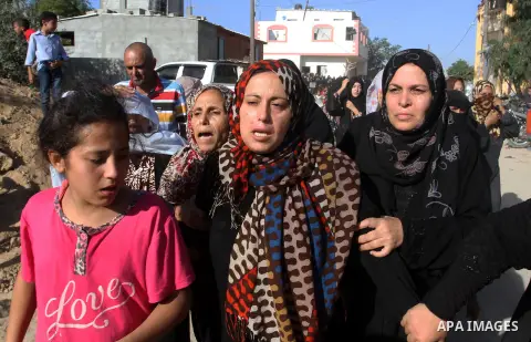 Relatives of Amir Jaber Abu Taimeh, a member of the Ezzedine al-Qassam Brigades, the military wing of the Palestinian Islamist movement Hamas, mourn during his funeral in Khan Yunis in the southern Gaza Strip on October...