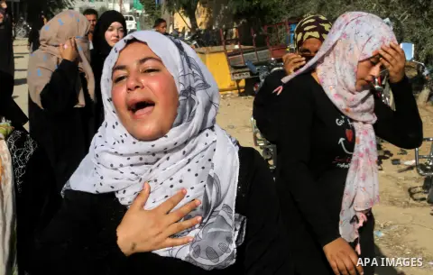 Relatives of Amir Jaber Abu Taimeh, a member of the Ezzedine al-Qassam Brigades, the military wing of the Palestinian Islamist movement Hamas, mourn during his funeral in Khan Yunis in the southern Gaza Strip on October...