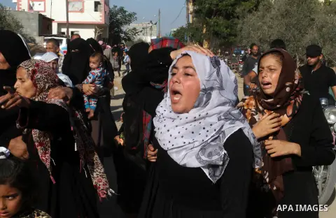 Relatives of Amir Jaber Abu Taimeh, a member of the Ezzedine al-Qassam Brigades, the military wing of the Palestinian Islamist movement Hamas, mourn during his funeral in Khan Yunis in the southern Gaza Strip on October...