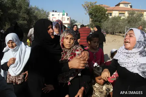 Relatives of Amir Jaber Abu Taimeh, a member of the Ezzedine al-Qassam Brigades, the military wing of the Palestinian Islamist movement Hamas, mourn during his funeral in Khan Yunis in the southern Gaza Strip on October...