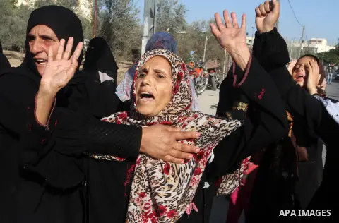 Relatives of Amir Jaber Abu Taimeh, a member of the Ezzedine al-Qassam Brigades, the military wing of the Palestinian Islamist movement Hamas, mourn during his funeral in Khan Yunis in the southern Gaza Strip on October...