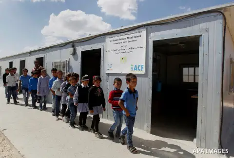 Palestinian students from Guwein primary mixed school stand outside their classrooms in south of al-Samou village in the West Bank city of Hebron, on Oct. 25, 2016. Guwein school funded by the French goverment learn insi...