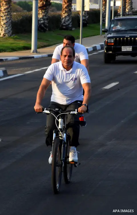 Egyptian President Abdel Fattah al-Sisi rides a bicycle at the street in the Red Sea resort of Sharm Al-Sheikh, in the South Sinai governorate, south of Cairo, Egypt, on Oct. 26, 2016. Photo by Egyptian President Office