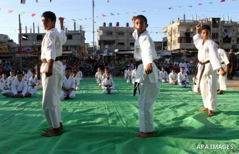 Palestinian children take part in a Karate graduation session at a club in Rafah, in the southern Gaza strip, on Oct. 28, 2016. Photo by Abed Rahim Khatib