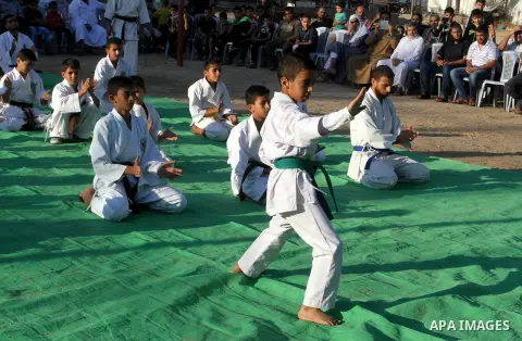 Palestinian children take part in a Karate graduation session at a club in Rafah, in the southern Gaza strip, on Oct. 28, 2016. Photo by Abed Rahim Khatib