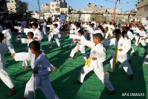 Palestinian children take part in a Karate graduation session at a club in Rafah, in the southern Gaza strip, on Oct. 28, 2016. Photo by Abed Rahim Khatib