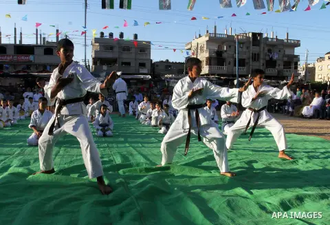 Palestinian children take part in a Karate graduation session at a club in Rafah, in the southern Gaza strip, on Oct. 28, 2016. Photo by Abed Rahim Khatib
