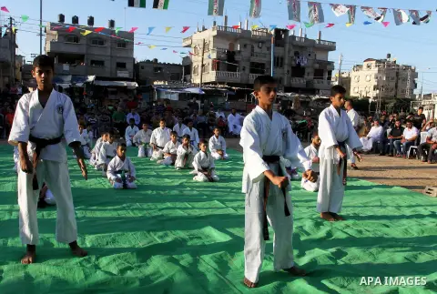 Palestinian children take part in a Karate graduation session at a club in Rafah, in the southern Gaza strip, on Oct. 28, 2016. Photo by Abed Rahim Khatib