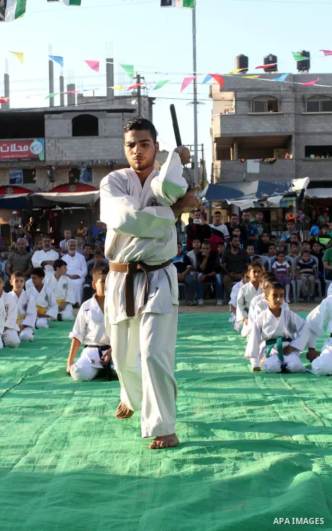Palestinian children take part in a Karate graduation session at a club in Rafah, in the southern Gaza strip, on Oct. 28, 2016. Photo by Abed Rahim Khatib