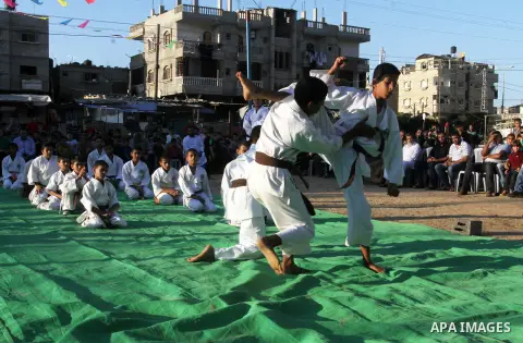 Palestinian children take part in a Karate graduation session at a club in Rafah, in the southern Gaza strip, on Oct. 28, 2016. Photo by Abed Rahim Khatib