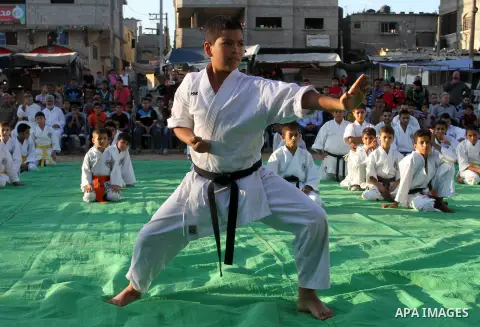 Palestinian children take part in a Karate graduation session at a club in Rafah, in the southern Gaza strip, on Oct. 28, 2016. Photo by Abed Rahim Khatib