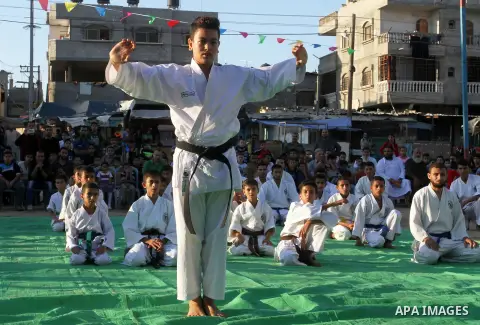 Palestinian children take part in a Karate graduation session at a club in Rafah, in the southern Gaza strip, on Oct. 28, 2016. Photo by Abed Rahim Khatib