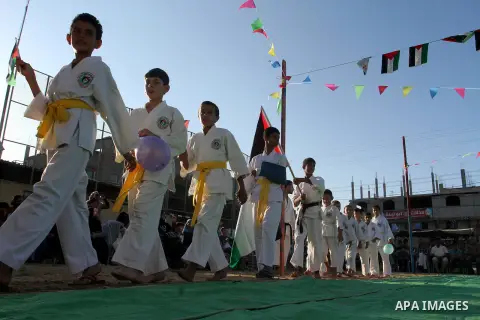 Palestinian children take part in a Karate graduation session at a club in Rafah, in the southern Gaza strip, on Oct. 28, 2016. Photo by Abed Rahim Khatib