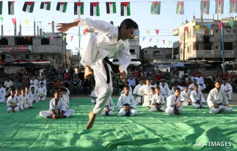 Palestinian children take part in a Karate graduation session at a club in Rafah, in the southern Gaza strip, on Oct. 28, 2016. Photo by Abed Rahim Khatib