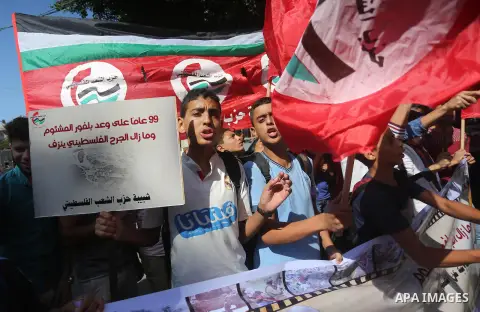 Palestinians hold banners during a demonstration in Gaza City to mark the anniversary of the Balfour Declaration on October 29, 2016. The 1917 Balfour Declaration is a formal statement of policy by the British government...