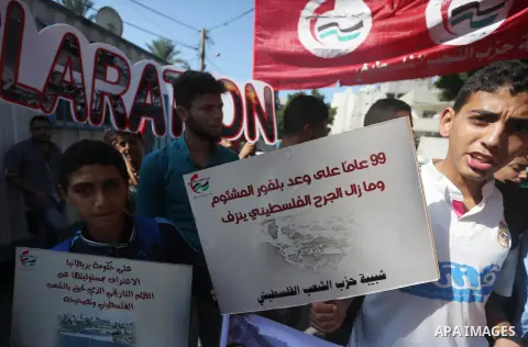 Palestinians hold banners during a demonstration in Gaza City to mark the anniversary of the Balfour Declaration on October 29, 2016. The 1917 Balfour Declaration is a formal statement of policy by the British government...